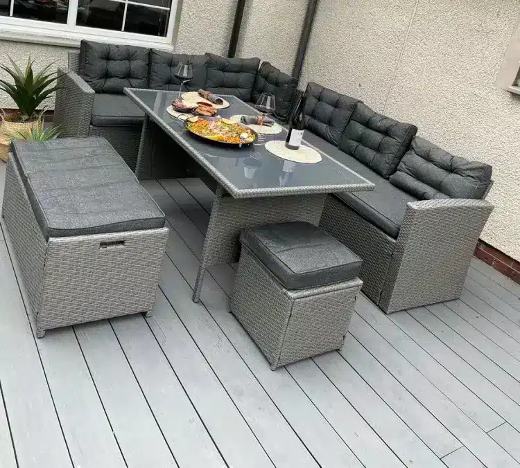 Alfresco Outdoor Living Created With Composite Decking Boards, Rattan Table And Chair Set With Dinner Served