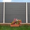 Anthracite Grey Grooved Composite Fencing With Plants And Grass
