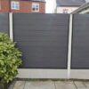 Anthracite Grey Grooved Fencing With Brush Next To Paving