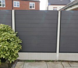 Anthracite Grey Grooved Fencing With Brush Next To Paving