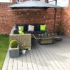 Sanded Anthracite Grey Composite Decking Board With Garden Rattan Corner Seat And Umbrella