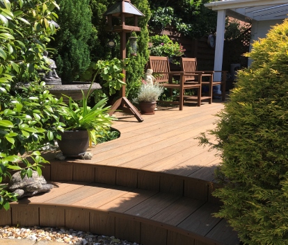 Curved Steps With Plants & Warm Brown Decking