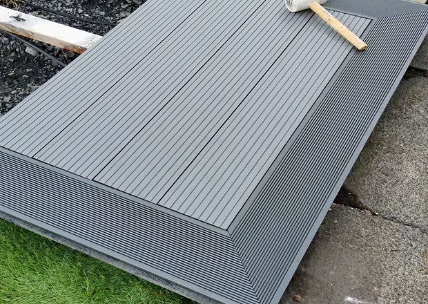 Composite decking being installed with picture frame and joists showing