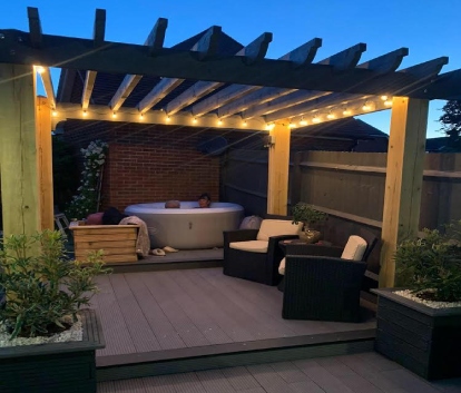 Pergola With Lighting & Hot Tub On Winters Night