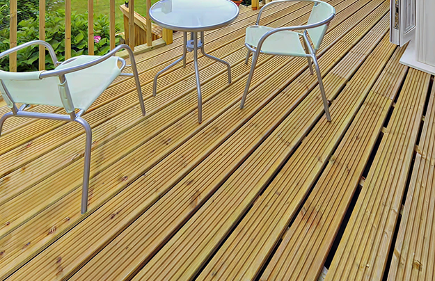 Timber decking boards with metal chairs and table