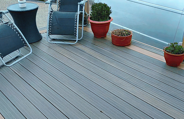 Composite decking in mixed brown colour on outdoor caravan patio