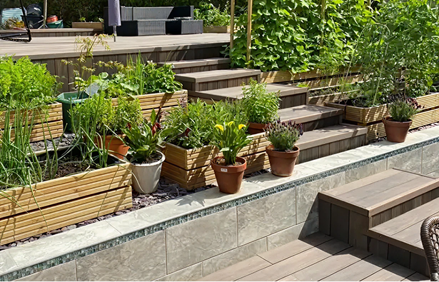 Close Up Of Raised Garden With Tiles & Planters