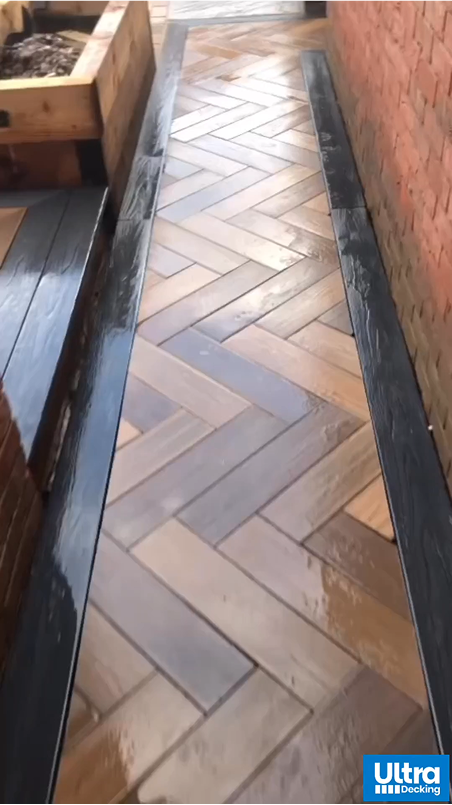 Composite Decking Boards In Mixed Brown Laid Like Herringbone