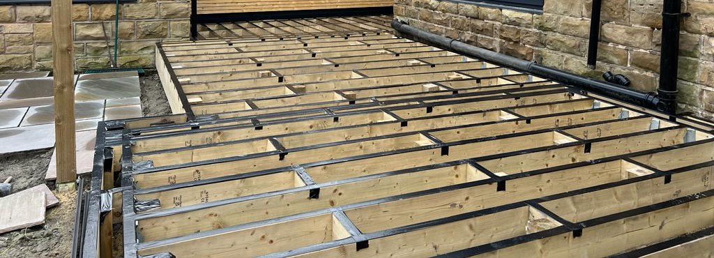 https://ultradecking.co.uk/wp-content/uploads/2025/08/Decking-Frame-With-Noggins-Sealed-Top-To-Protect.jpg